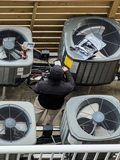 HVAC contractor performing maintenance on HVAC system in Rockford, TN